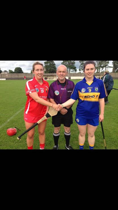  Cork Camogie Captain Jennifer Barry & Tipperary Captain Michaela Graham with referee Philip Dee prior to the Munster intermediate Camogie Final played in Bruff.